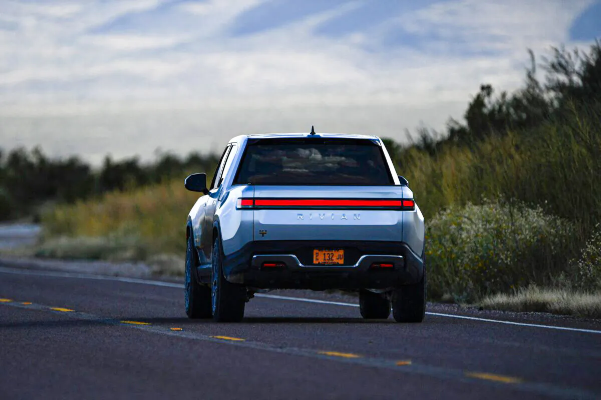 A Rivian R1T electric truck drives down a highway near the entrance to Blue Origin's Launch Site One outside of Van Horn, Texas, on Oct. 12, 2021. (Patrick T. Fallon/AFP via Getty Images)
