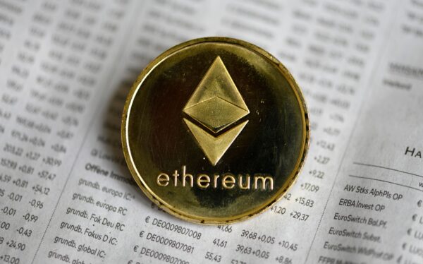 The photo shows a physical imitation of a Ethereum cryptocurrency