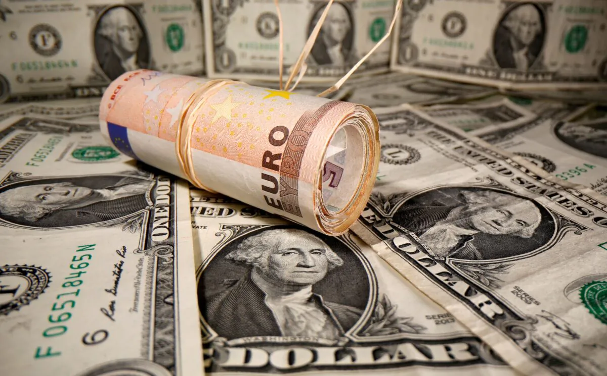 Rolled Euro banknotes are placed on U.S. Dollar banknotes in this illustration taken on May 26, 2020. (Dado Ruvic/Illustration/Reuters)