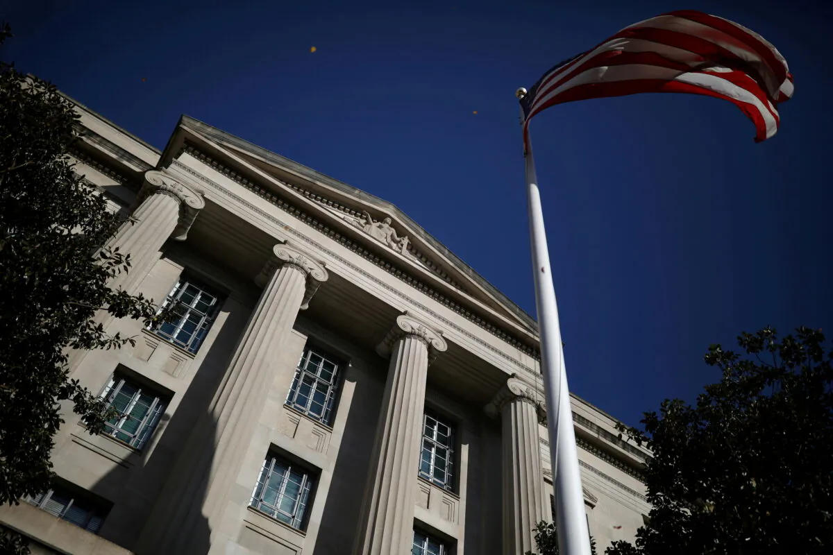 An American flag waves outside the U.S. Department of Justice Building in Washington, on Dec. 2, 2020. (Tom Brenner/Reuters)