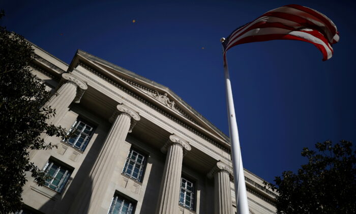 An American flag waves outside the U.S. Department of Justice Building in Washington, on Dec. 2, 2020. (Tom Brenner/Reuters)