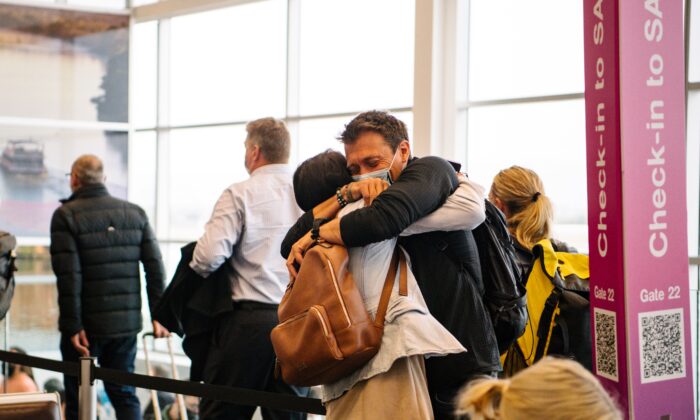 Two people are seen hugging each other after one arrives from a Melbourne flight this morning in Adelaide, Tuesday, November 23, 2021. (AAP Image/Morgan Sette) 