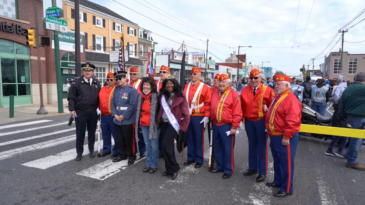 All-American Ambassador Tanya Amir (center), with members of the Philadelphia Marine Corps League at the 44th annual Mayfair-Holmesburg Thanksgiving Parade in Northeast Philadelphia on Nov. 21, 2021. (Screenshot via NTD TV)