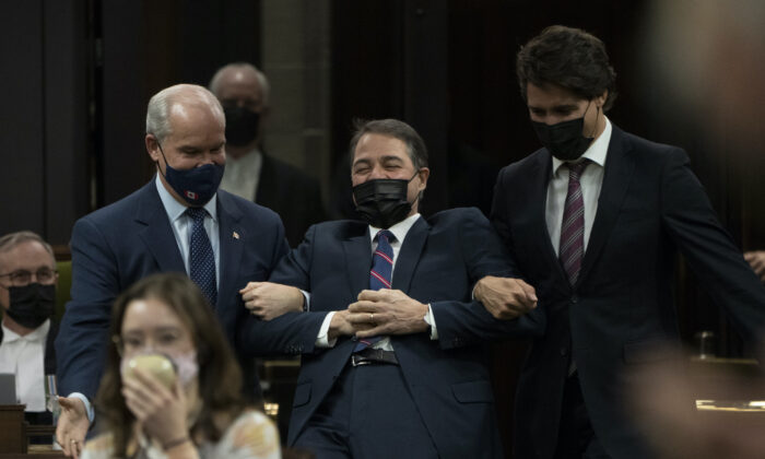 Anthony Rota jokingly fights being escorted by Prime Minister Justin Trudeau and Conservative Leader Erin O'Toole to the Speaker's chair after being elected as the Speaker of the House of Commons in Ottawa on Nov. 22, 2021. ( Canadian Press/Adrian Wyld)