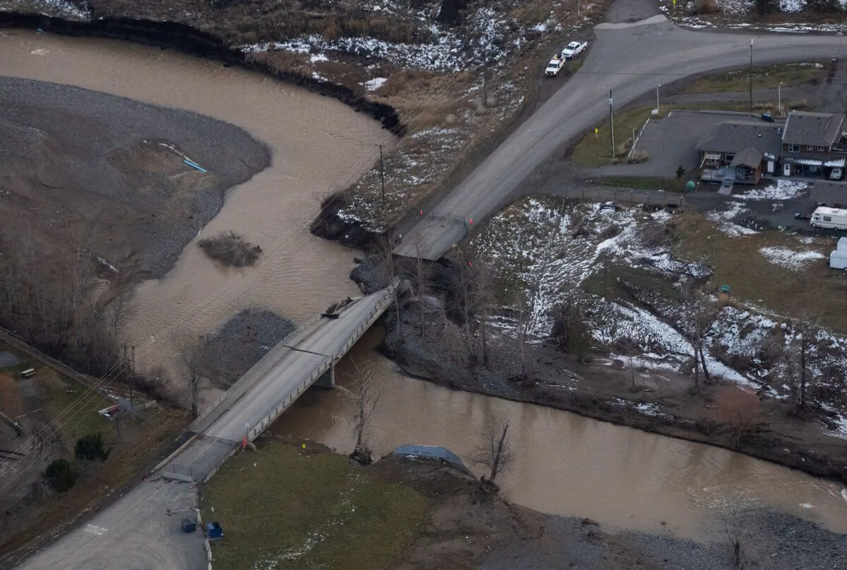 Aerial photo shows a collapsed section of a bridge due to severe flooding, in Merritt, B.C., on Nov. 22, 2021. (The Canadian Press/Darryl Dyck)
