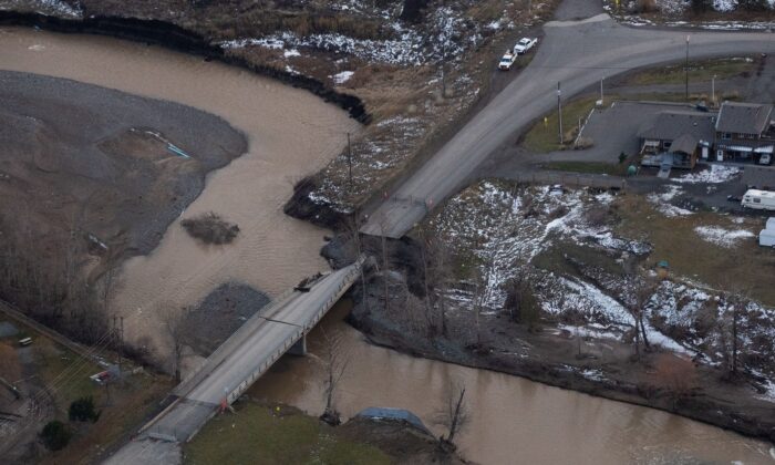 Aerial photo shows a collapsed section of a bridge due to severe flooding, in Merritt, B.C., on Nov. 22, 2021. ( Canadian Press/Darryl Dyck)