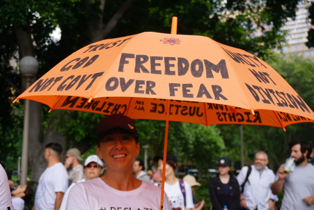 Protestor holding an umbrella saying "Freedom Over Fear" at the Freedom Rally in Sydney, Australia on Nov. 20, 2021. (Nina Nguyen/The Epoch Times)
