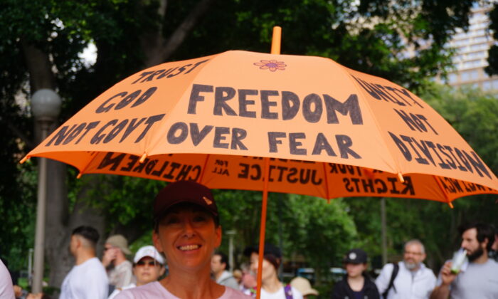 Protestor holding an umbrella saying "Freedom Over Fear" at the Freedom Rally in Sydney, Australia on Nov. 20, 2021. (Nina Nguyen/The Epoch Times)