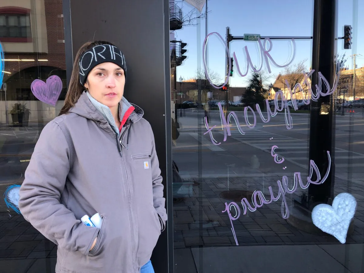 Waukesha local Elizabeth Boyd, who works with Smart Asset Realty, said she met her coworkers at their business in downtown Waukesha to draw inspiring messages on their windows to fellow Waukegans on Nov. 22, 2021, following an attack on their town's Christmas parade. (Cara Ding/The Epoch Times)