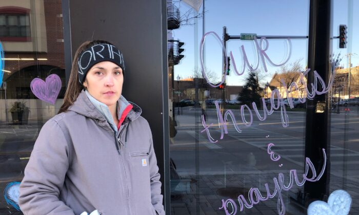 Waukesha local Elizabeth Boyd, who works with Smart Asset Realty, said she met her coworkers at their business in downtown Waukesha to draw inspiring messages on their windows to fellow Waukegans on Nov. 22, 2021, following an attack on their town's Christmas parade. (Cara Ding/The Epoch Times)