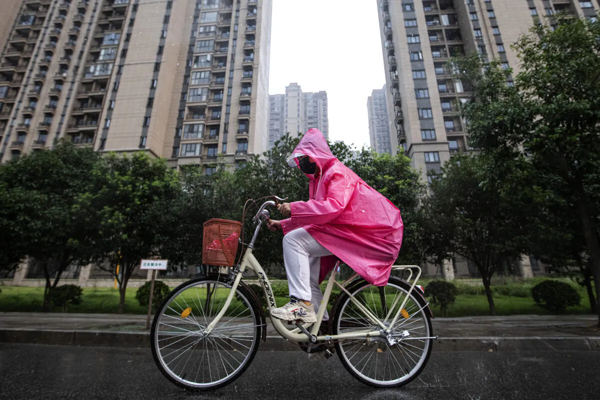 A resident cycles through the Evergrande Changqing community in the rain in Wuhan, Hubei Province, China, on Sept. 24, 2021. (Getty Images)