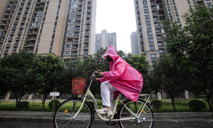 A resident cycles through the Evergrande Changqing community in the rain in Wuhan, Hubei Province, China, on Sept. 24, 2021. (Getty Images)