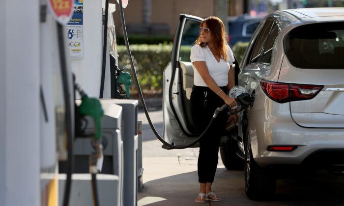 A customer pumps gas into her vehicle in Miami, Fla., on Nov. 22, 2021. (Joe Raedle/Getty Images)