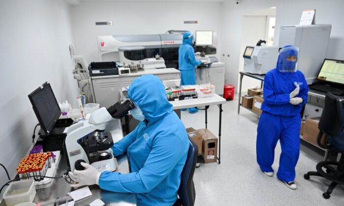 Health personnel work at the COVID-19 area of the Microanalisis Integral Laboratory in the Versalles Clinic, on June 25, 2020 in Cali, Colombia. (Luis Robayo/AFP via Getty Images)