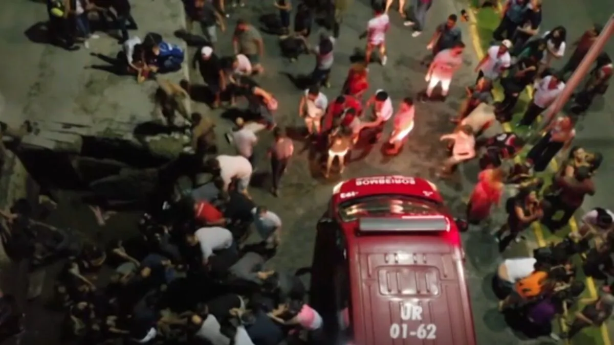 Firefighters rescue victims who fell into a river after a sidewalk collapsed in Joinville, Santa Catarina, Brazil, on Nov. 22, 2021, in a still from video. (Courtesy of Leoh Julio via AP/Screenshot via The Epoch Times)