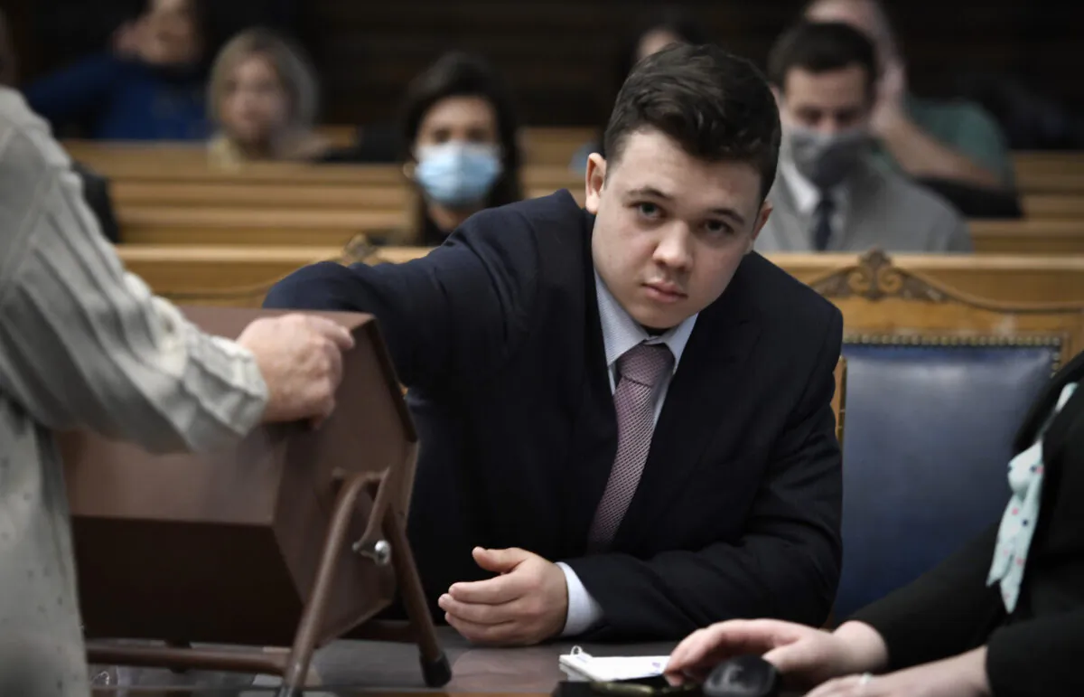 Kyle Rittenhouse pulls numbers of jurors out of a tumbler during his trial at the Kenosha County Courthouse, in Kenosha, Wis., on Nov. 16, 2021. (Getty Images)