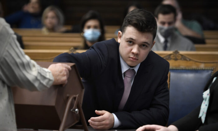 Kyle Rittenhouse pulls numbers of jurors out of a tumbler during his trial at the Kenosha County Courthouse, in Kenosha, Wis., on Nov. 16, 2021. (Getty Images)