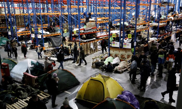 Migrants gather at a transport and logistics center near the Belarusian-Polish border, in the Grodno region, Belarus, on Nov. 24, 2021. (Kacper Pempel/Reuters)