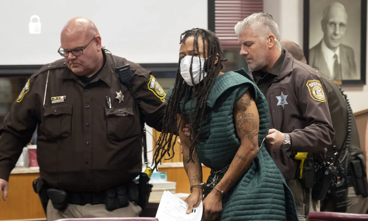 Darrell Brooks is escorted out of the courtroom after making his initial appearance in Waukesha County Court in Waukesha, Wis., on Nov. 23, 2021. (Mark Hoffman/Milwaukee Journal-Sentinel via AP, Pool)