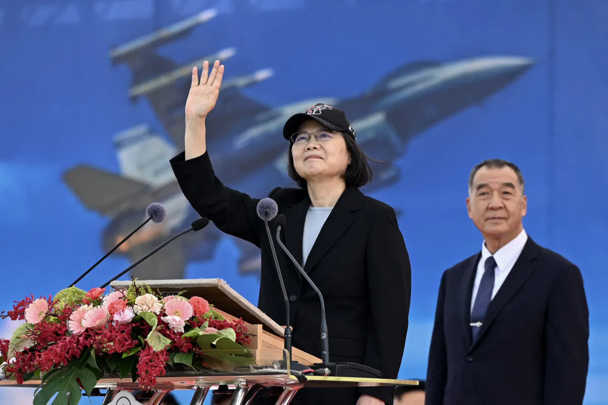 Taiwan President Tsai Ing-wen waves at an upgraded U.S.-made F-16 V fighter as Defense Minister Chiu Kuo-cheng looks on during a ceremony at the Chiayi Air Force in southern Taiwan on Nov. 18, 2021. (Sam Yeh/AFP via Getty Images)