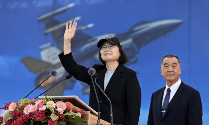 Taiwan President Tsai Ing-wen waves at an upgraded U.S.-made F-16 V fighter as Defense Minister Chiu Kuo-cheng looks on during a ceremony at the Chiayi Air Force in southern Taiwan on Nov. 18, 2021. (Sam Yeh/AFP via Getty Images)