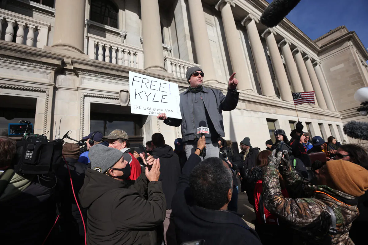 A supporter of Kyle Rittenhouse celebrates after learning that Rittenhouse was acquitted of all charges, outside of the Kenosha County Courthouse in Kenosha, Wis., on Nov. 19, 2021. (Scott Olson/Getty Images)