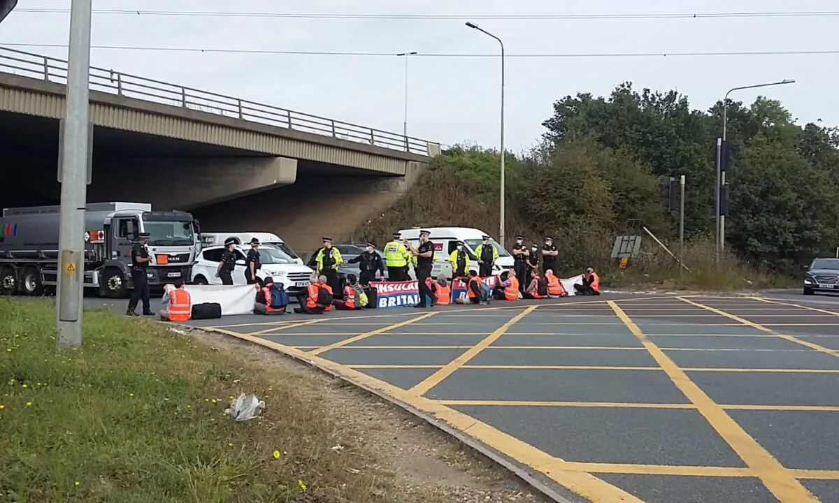 Handout photo showing climate change activists from Insulate Britain blocking the M25 motorway on Sept. 13, 2021. (Insulate Britain)