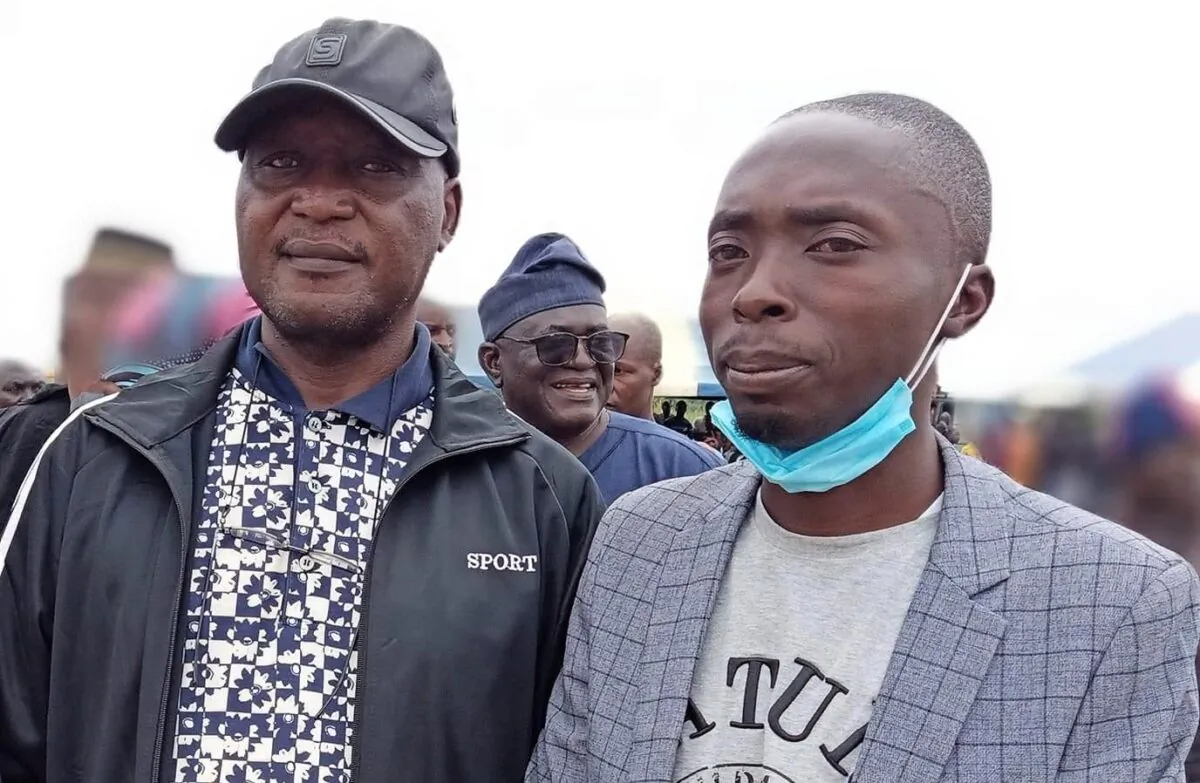 Luka Binniyat, left and Lawrence Zongo, right, contributors to The Epoch Times, standing at a mass burial for victims of the Madamai village massacre, near Madamai, Nigeria, on Sept. 30, 2021. (Bitrus Adamu) 