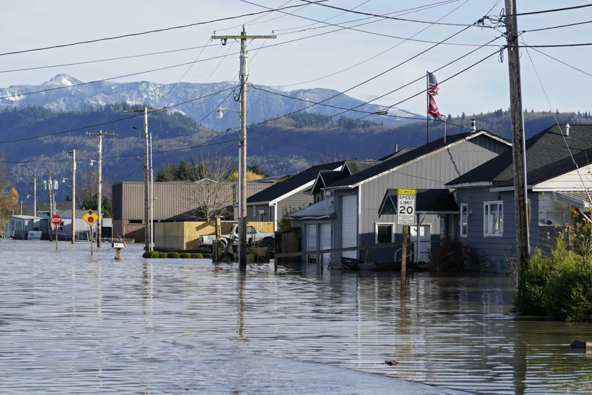 Floodwater inundates homes along a road in Sumas, Wash., on Nov. 17, 2021. (Elaine Thompson/AP Photo)