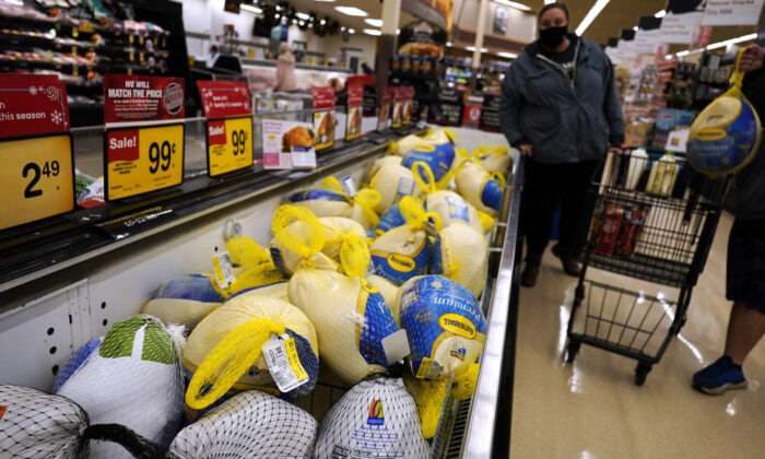 People shop for frozen turkeys at a grocery store in Mount Prospect, Ill., on Nov. 17, 2021. (Nam Y. Huh/AP Photo)
