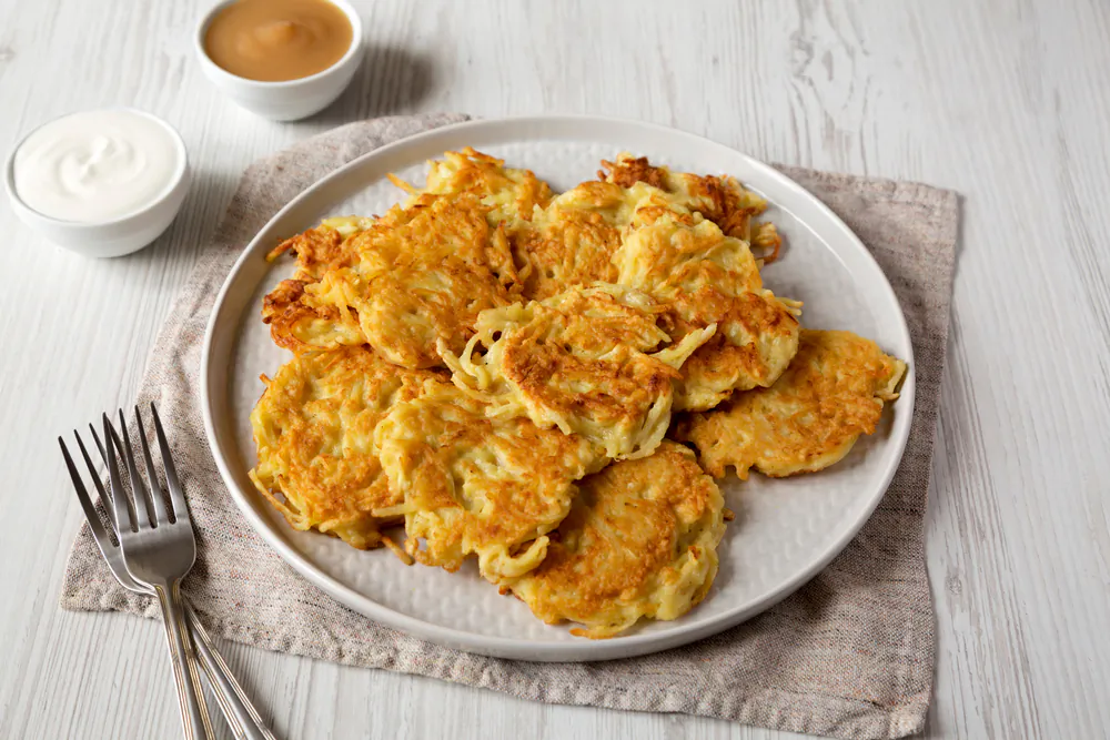 Latkes, fried potato pancakes, are traditionally served for Hanukkah—but can be enjoyed any time of year. (Liudmyla Chuhunova/Shutterstock)