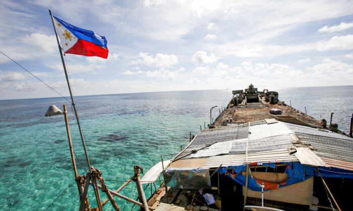 A Philippine flag flutters from BRP Sierra Madre, a dilapidated Philippine Navy ship that has been aground since 1999 and became a Philippine military detachment on the disputed Second Thomas Shoal, part of the Spratly Islands, in the South China Sea, on March 29, 2014. (Erik De Castro/Reuters)