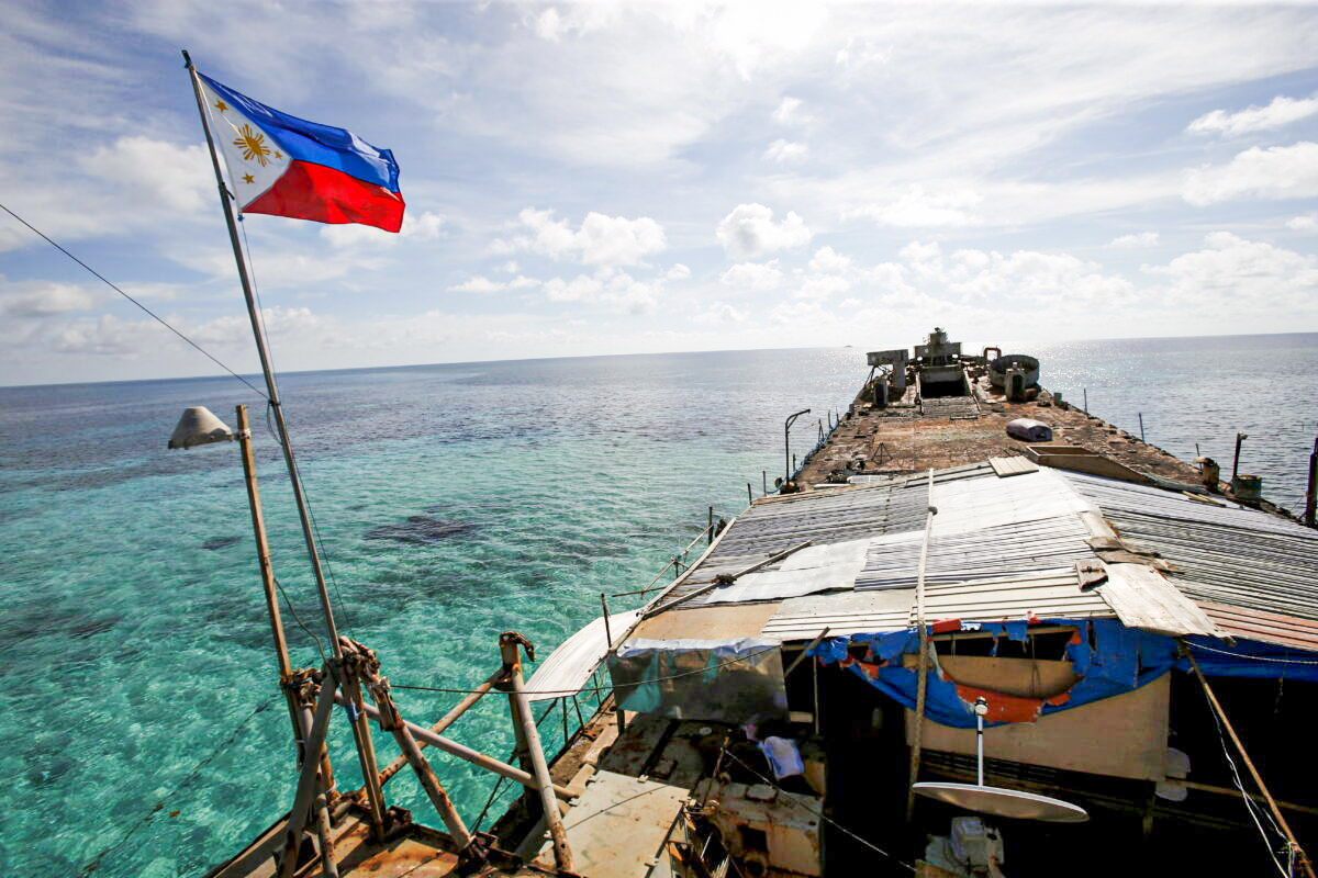 FILE PHOTO: A Philippine flag flutters from BRP Sierra Madre, a dilapidated Philippine Navy ship that has been aground since 1999 and became a Philippine military detachment on the disputed Second Thomas Shoal