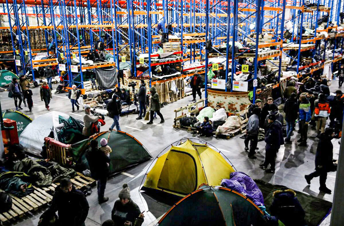 Migrants gather at a transport and logistics center near the Belarusian-Polish border, in the Grodno region, Belarus, on Nov. 24, 2021. (Kacper Pempel/Reuters)
