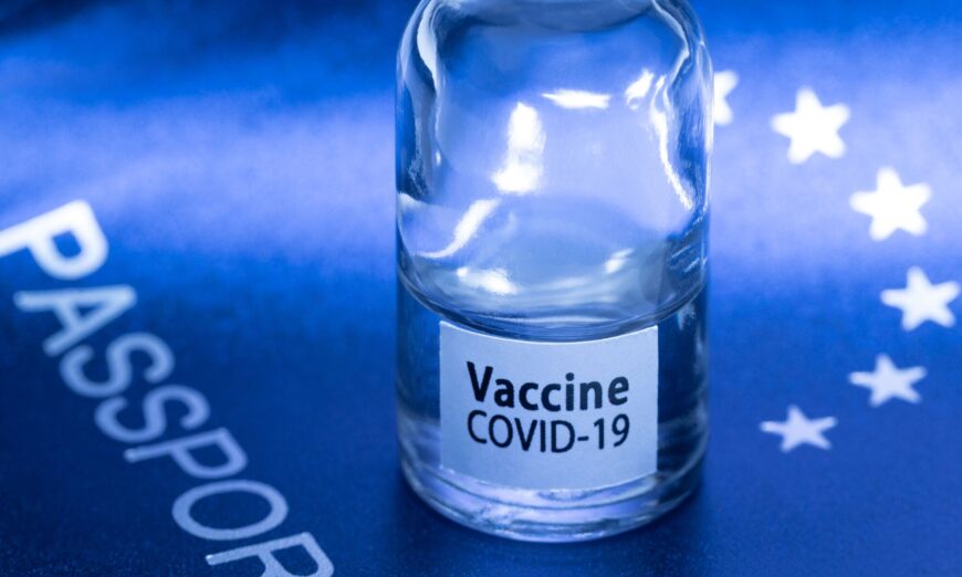 A vaccine vial on a European passport in Paris, on March 3, 2021. (Joel Saget/AFP via Getty Images)