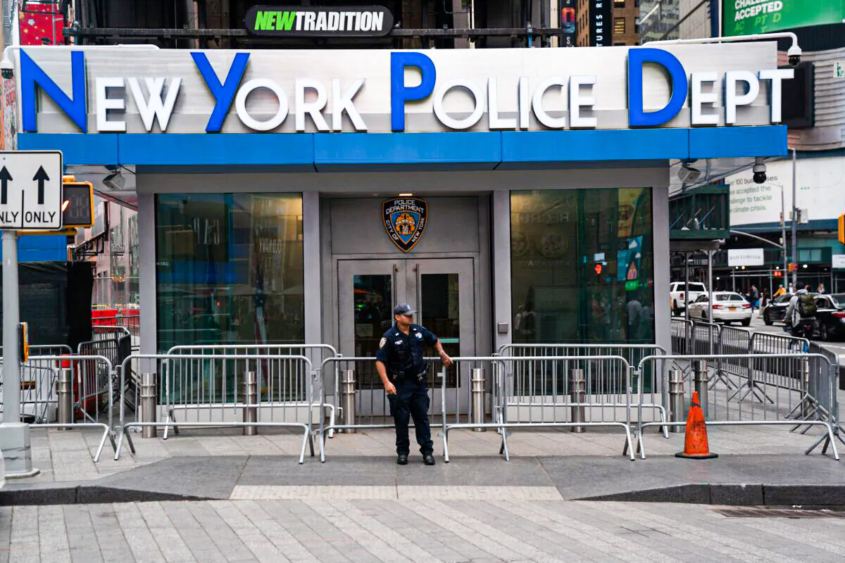An NYPD officer stands guard outside the New York Police Department in Time Square on Oct. 5, 2021 in New York. (Bryan R. Smith/AFP via Getty Images)