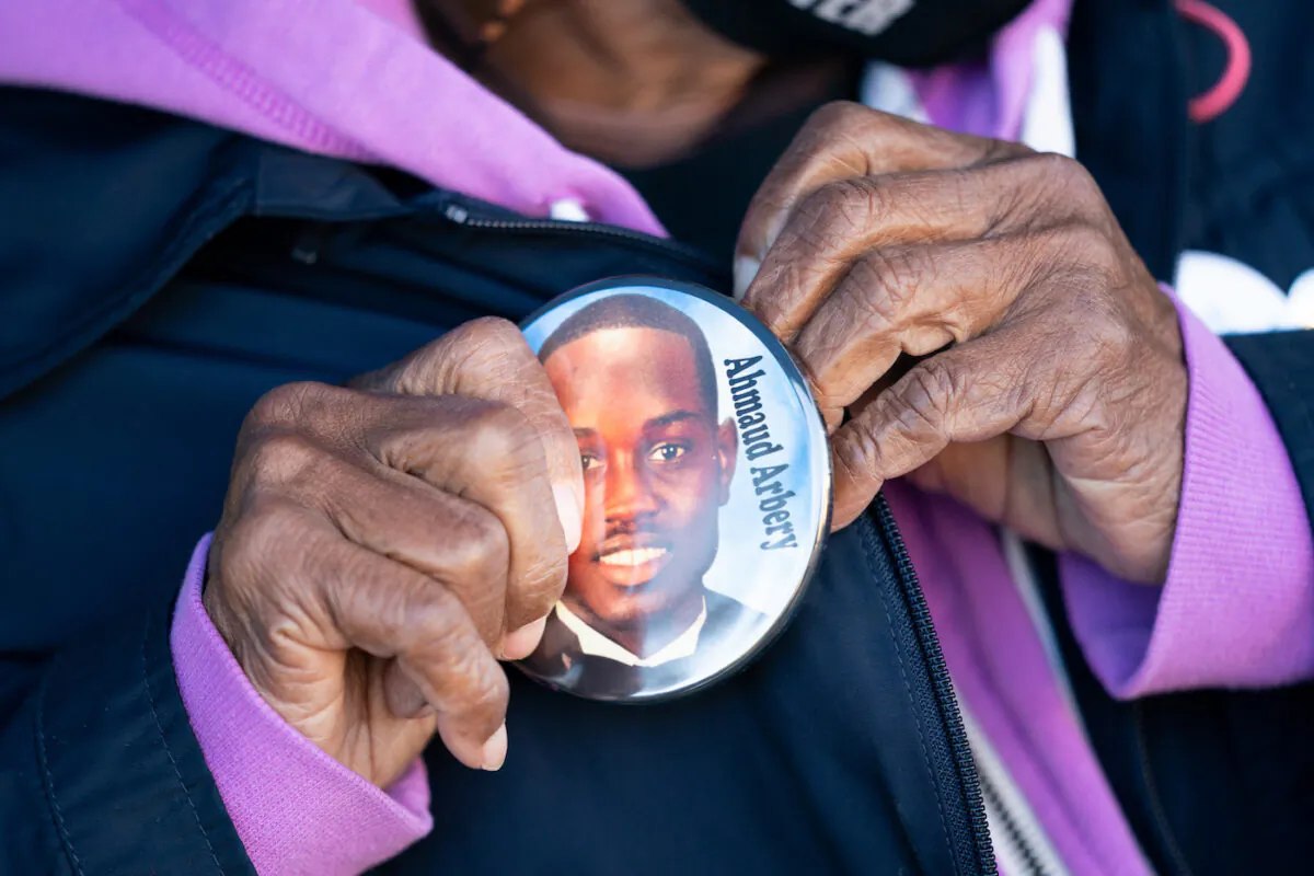 Annie Polite puts on a button for Ahmaud Arbery outside the Glynn County Courthouse as the jury deliberates in the trial of the killers of Ahmaud Arbery on Nov. 24, 2021 in Brunswick, Georgia. (Sean Rayford/Getty Images)