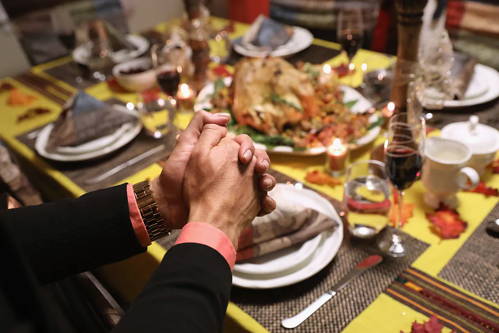 Families pray before Thanksgiving dinner in Stamford, Conn., on Nov. 24, 2016. (John Moore/Getty Images)