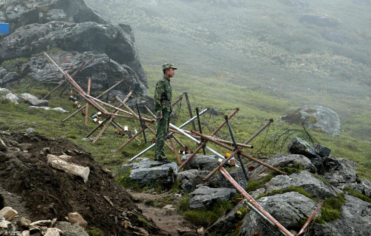 A Chinese soldier stands guard on the Chinese side of the ancient Nathu La border crossing between India and China, on July 10, 2008. (Dipendu Dutta/AFP via Getty Images)