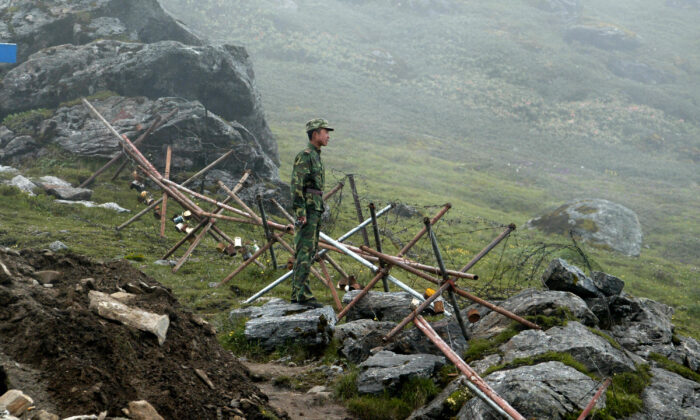 A Chinese soldier stands guard on the Chinese side of the ancient Nathu La border crossing between India and China, on July 10, 2008. (Dipendu Dutta/AFP via Getty Images)