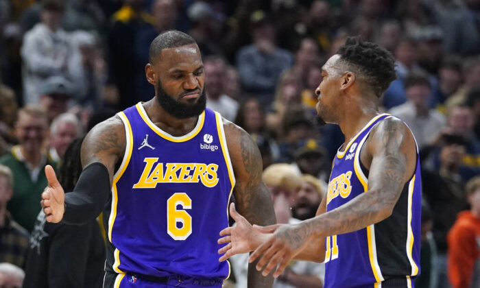 Los Angeles Lakers' LeBron James (6) celebrates with Malik Monk (11) during overtime of the team's NBA basketball game against the Indiana Pacers, in Indianapolis, on Nov. 24, 2021. (Darron Cummings/AP Photo)