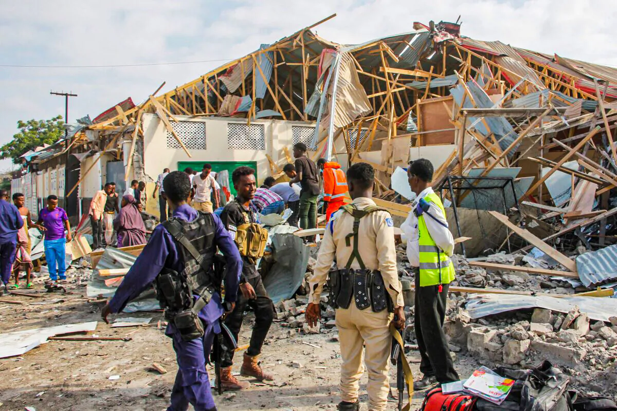 Security forces and rescue workers search for bodies at the scene of a blast in Mogadishu, Somalia on Nov. 25, 2021. (Farah Abdi Warsameh/AP Photo)
