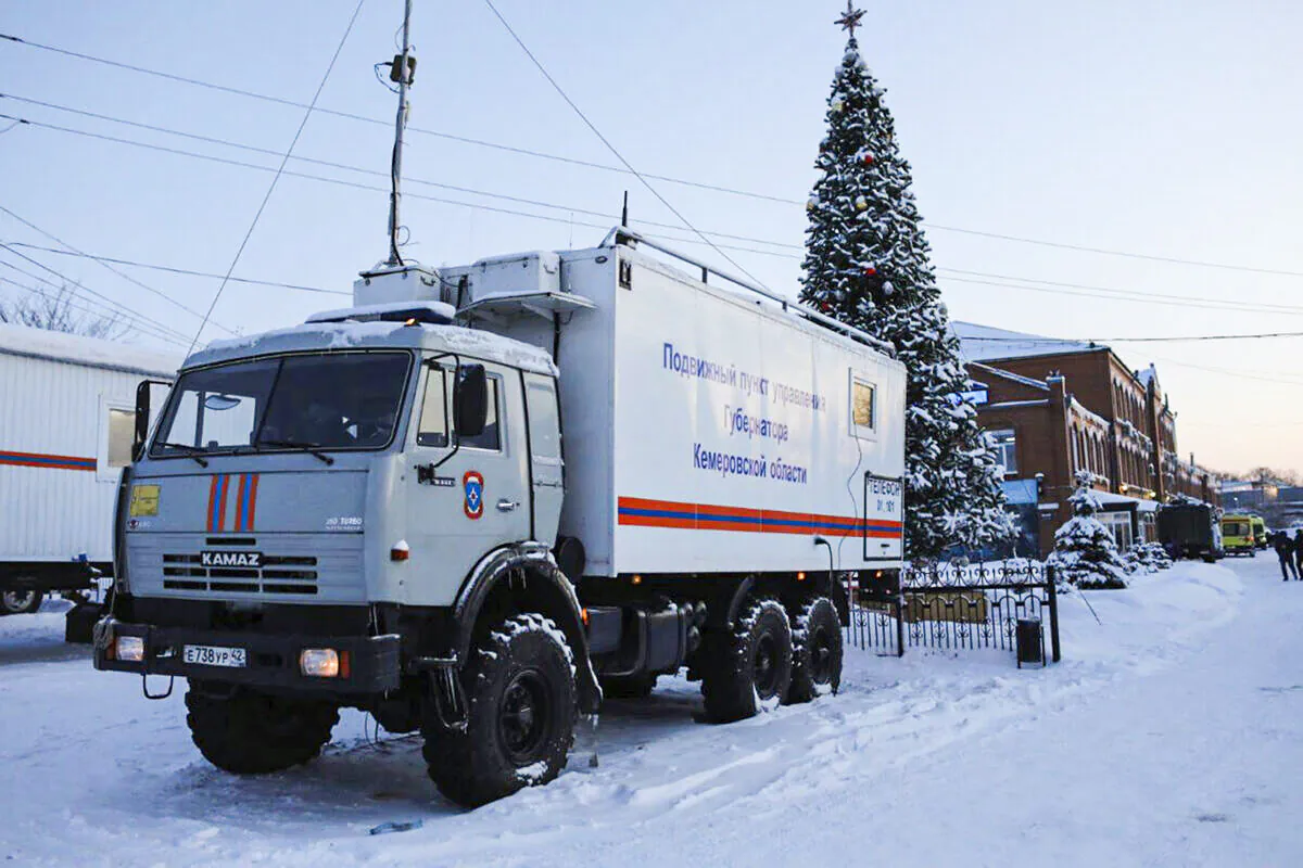 A Russian Emergency Ministry truck is parked at the Listvyazhnaya mine, right, near Belovo, in the Kemerovo region of southwestern Siberia, Russia on Nov. 26, 2021. (Sergei Gavrilenko/AP Photo)