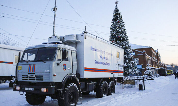 A Russian Emergency Ministry truck is parked at the Listvyazhnaya mine, right, near Belovo, in the Kemerovo region of southwestern Siberia, Russia on Nov. 26, 2021. (Sergei Gavrilenko/AP Photo)