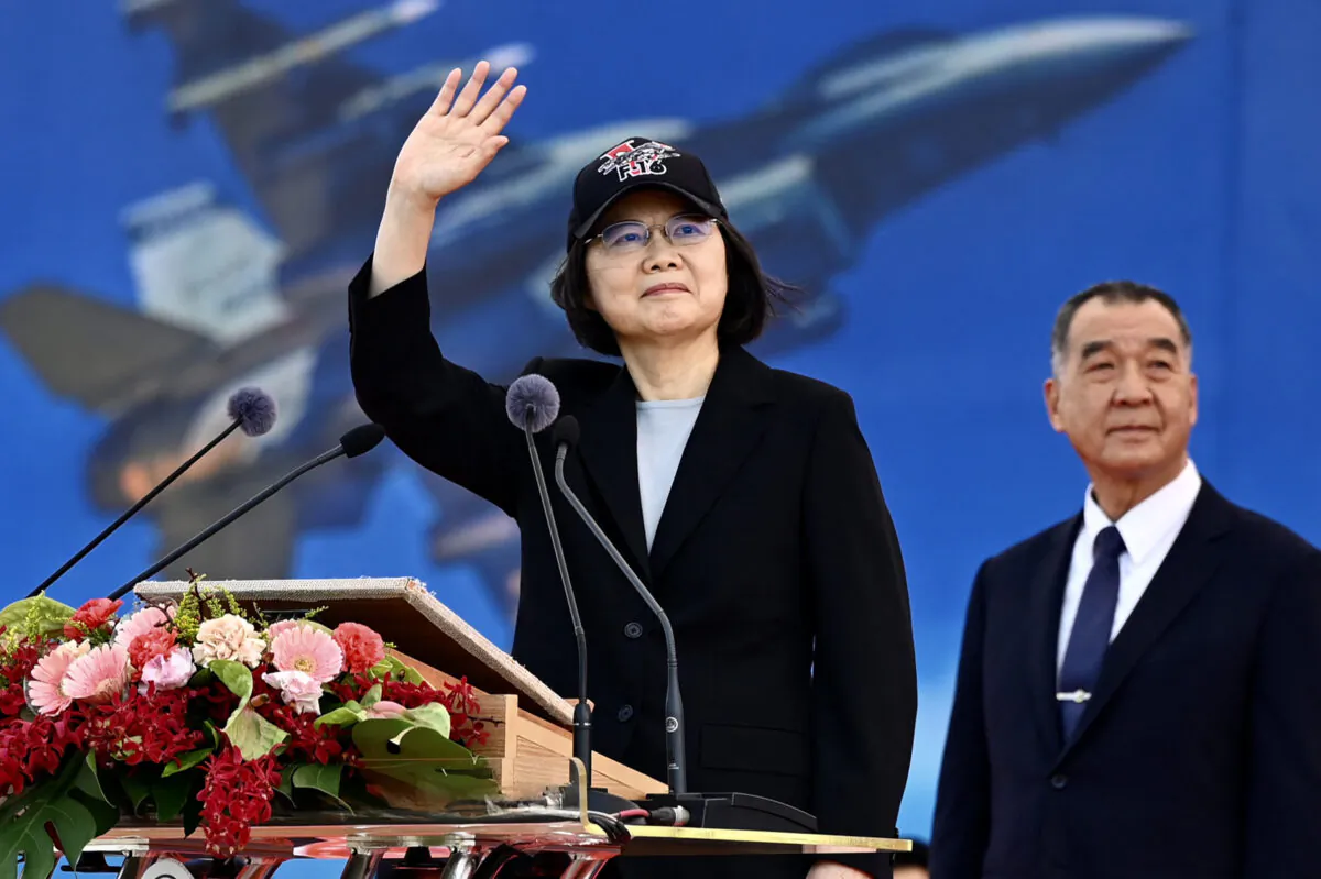 Taiwan President Tsai Ing-wen waves at an upgraded U.S.-made F-16 V fighter as Defence Minister Chiu Kuo-cheng looks on during a ceremony at the Chiayi Air Force in southern Taiwan on Nov. 18, 2021. (Sam Yeh/AFP via Getty Images)