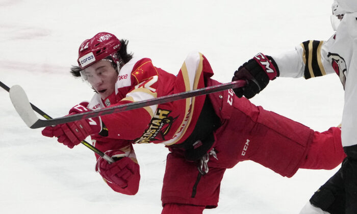 Kunlun Red Star's Parker Foo battles for the puck during the Kontinental Hockey League ice hockey match between Kunlun Red Star Beijing and Avangard Omsk in Mytishchi, outside Moscow, Russia, on Nov. 17, 2021. (Pavel Golovkin/AP Photo)