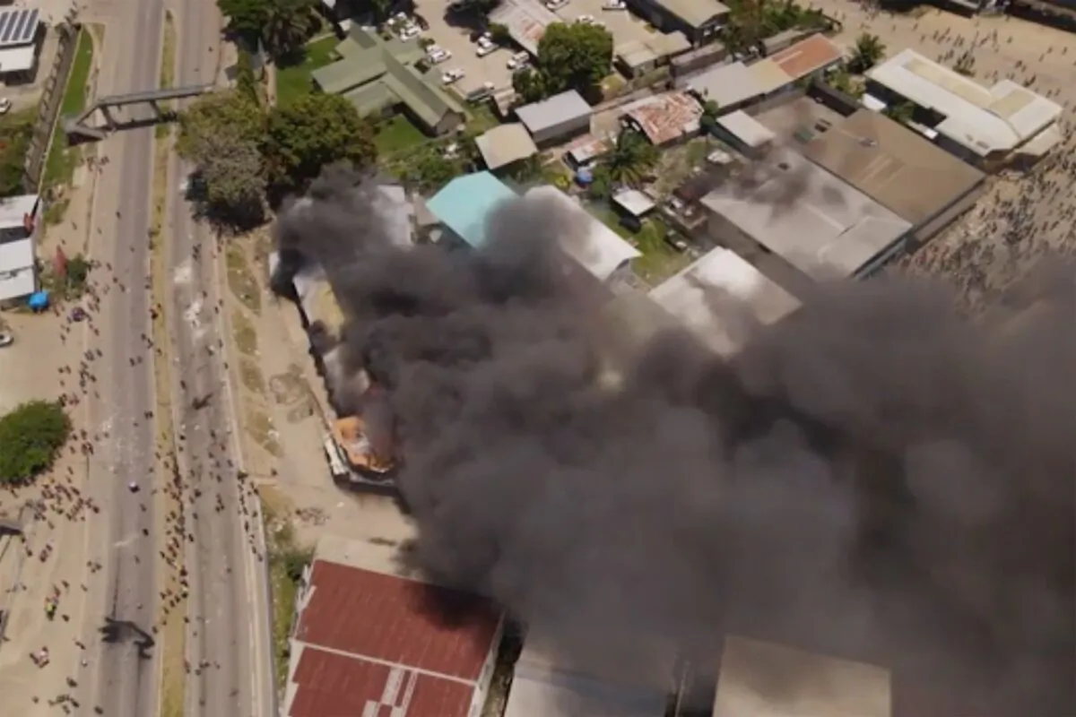 Smoke rises from burning buildings during a protest in the capital of Honiara, Solomon Islands, on Nov. 25, 2021. (Australian Broadcasting Corporation via AP)