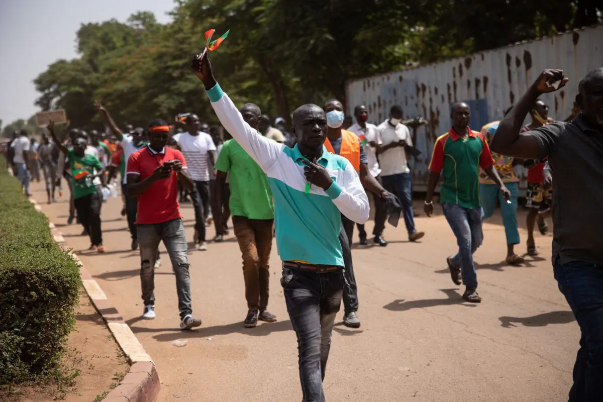 People take part in a march called by the opposition to protest against the security situation worsening and asking for a response to jihadist attacks, in Ouagadougou, on July 3, 2021. (Olympia de Maismont/AFP via Getty Images)