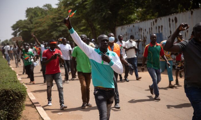 People take part in a march called by the opposition to protest against the security situation worsening and asking for a response to jihadist attacks, in Ouagadougou, on July 3, 2021. (Olympia de Maismont/AFP via Getty Images)