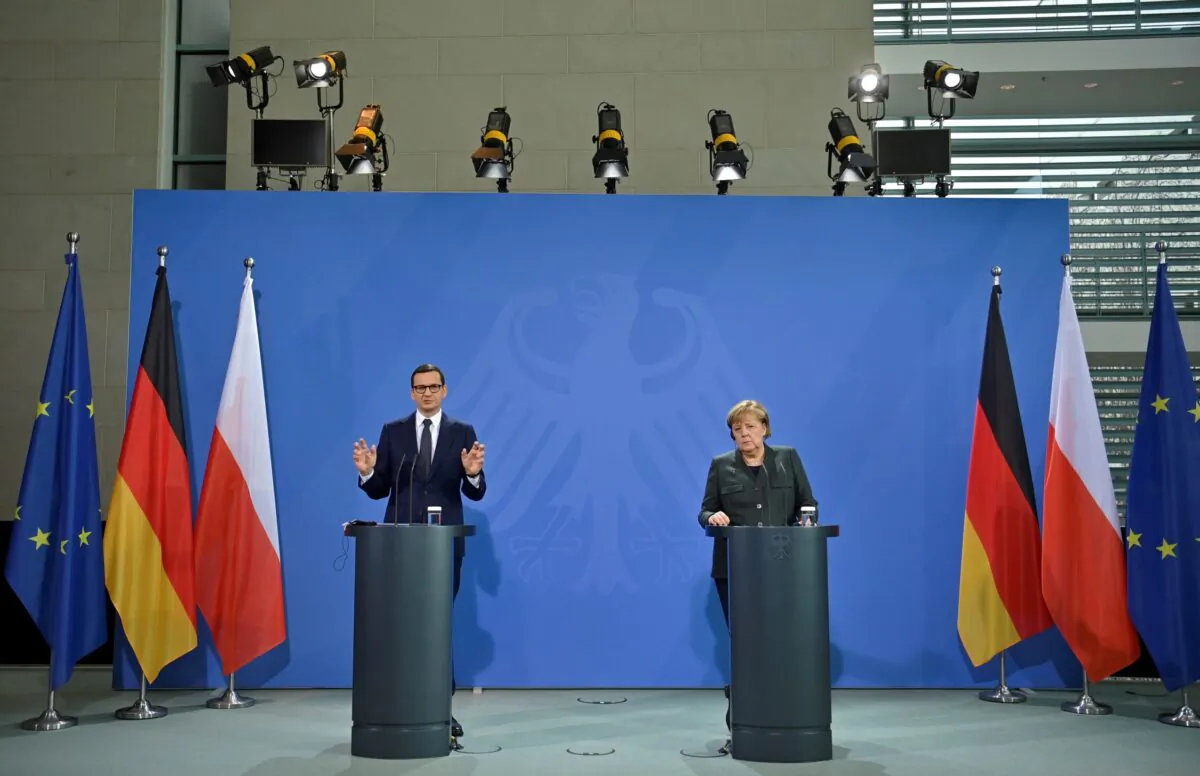 German Chancellor Angela Merkel and Polish Prime Minister Mateusz Morawiecki speak to the media after talks in Berlin, Germany on Nov. 25, 2021. (John MacDougall/Pool via Reuters)